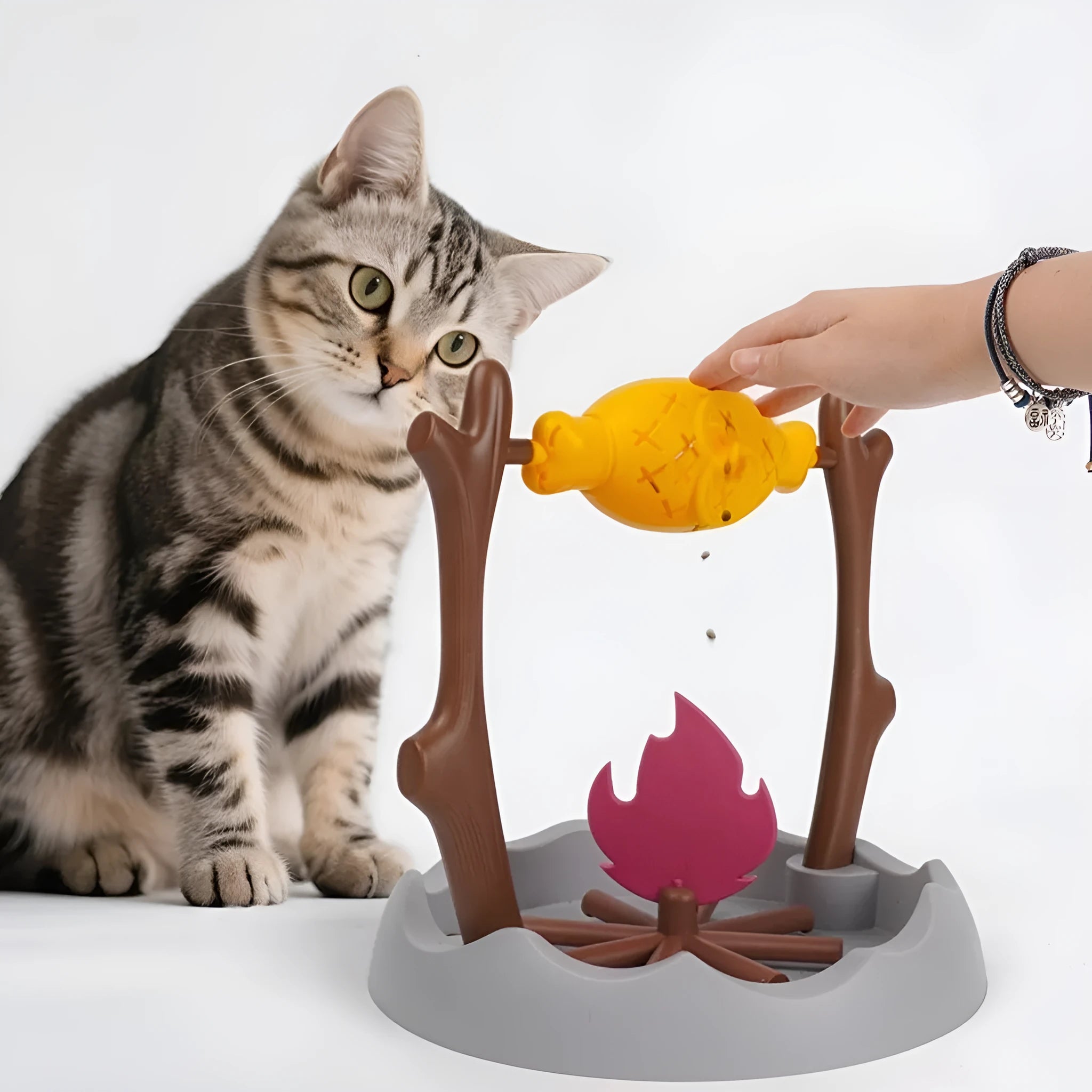 Barbecue-style tumbling cat treat feeder measuring 30x30x29cm with plastic construction