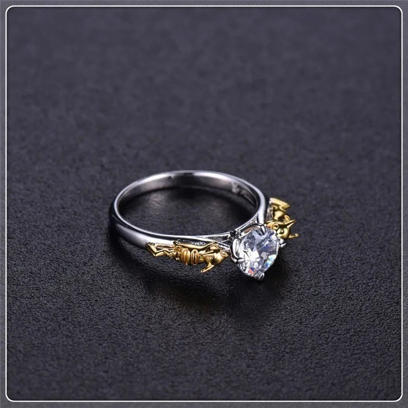 Black gold copper crown crystal ring for cosplay on a grey background.
