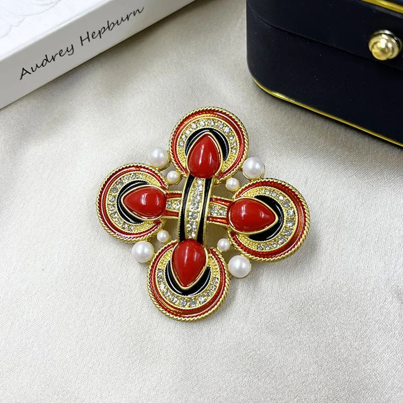 Close-up of a zinc alloy baroque brooch with a central crystal cross in a vintage style.