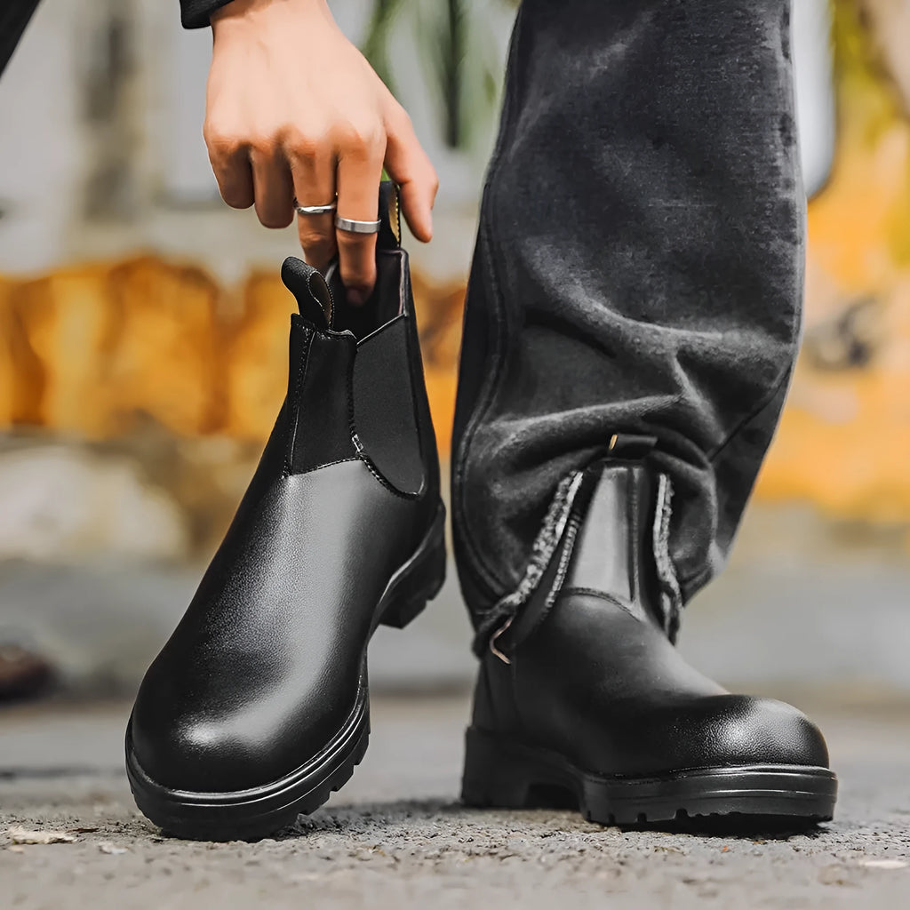 Vintage frosted faux leather Chelsea boots for men and women on a neutral background.