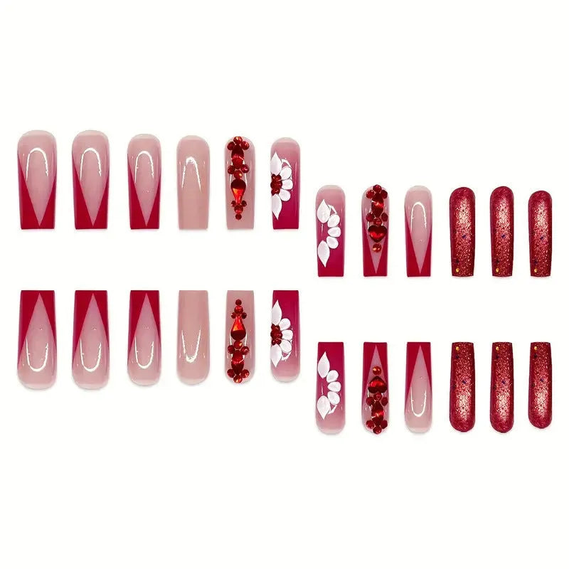 Long coffin shaped press-on false nails with red diamond gemstone and sweet flower pattern decoration.