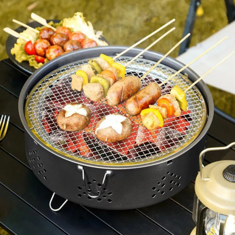 Portable stainless steel charcoal BBQ grill with detachable parts and a carry bag, shown in grey.