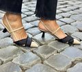 Women's apricot and black colour block stiletto sandals with a pointed toe and buckle fastening.