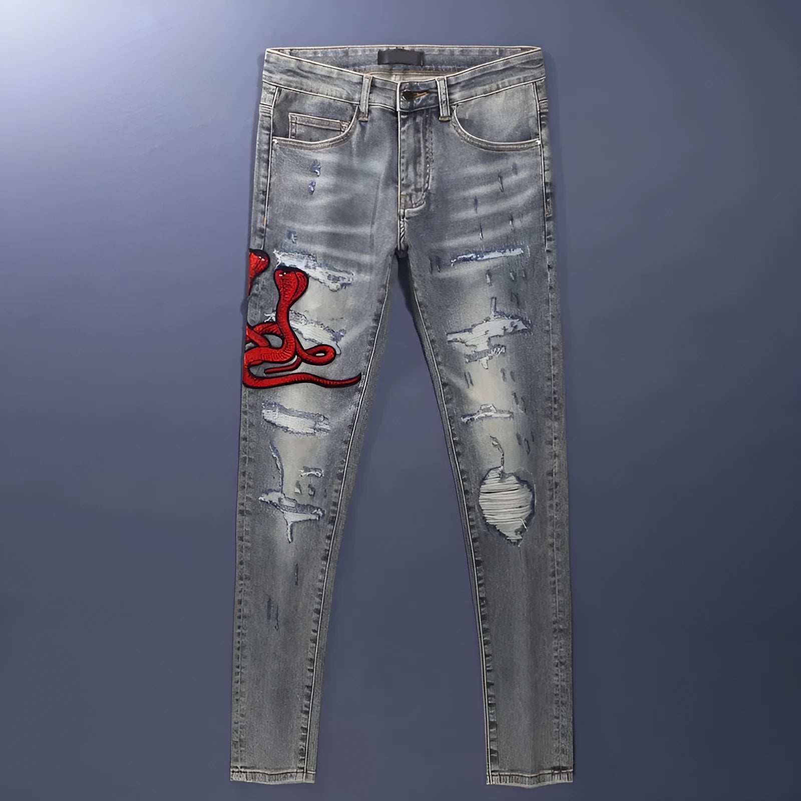 Men's slim fit jeans in a washed-out old colour with distressed hole and patch details on the legs.