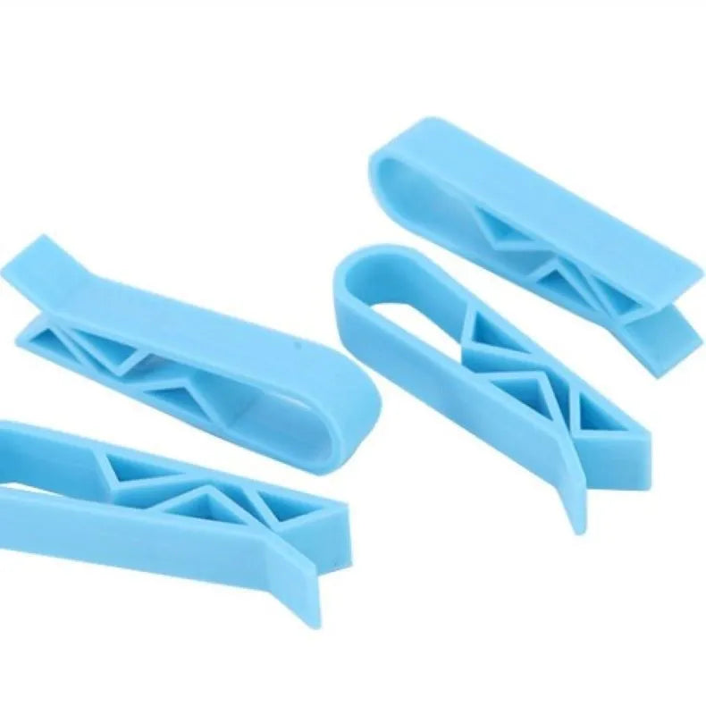 Transparent plastic non-slip clip for holding a garbage bag on the rim of a bin.