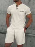 Man wearing grey waffle texture short sleeve polo with zip front and matching shorts