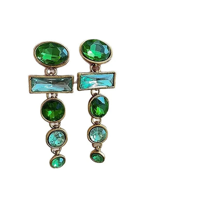 Close-up of green gradient geometric alloy earrings with long tassels and sparkling inlaid zircons.