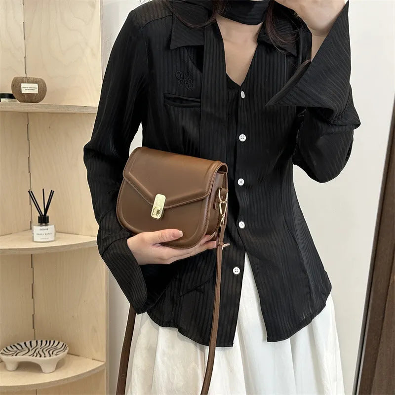 Soft niche texture PU messenger bag in horizontal square clamshell design shown in black colour.