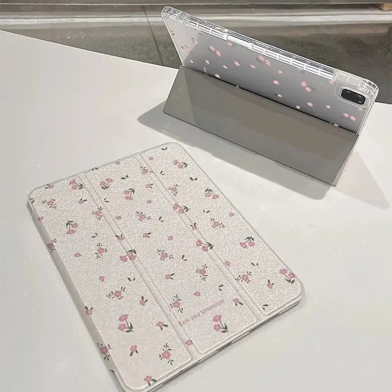 Transparent floral tri-fold iPad protective case showing magnetic stand functionality for Apple tablet models