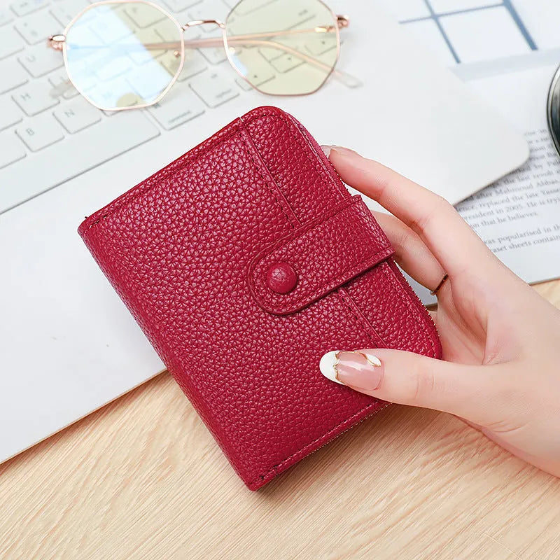 Ladies' short bifold wallet with embossed lychee pattern in PU leather, shown closed.