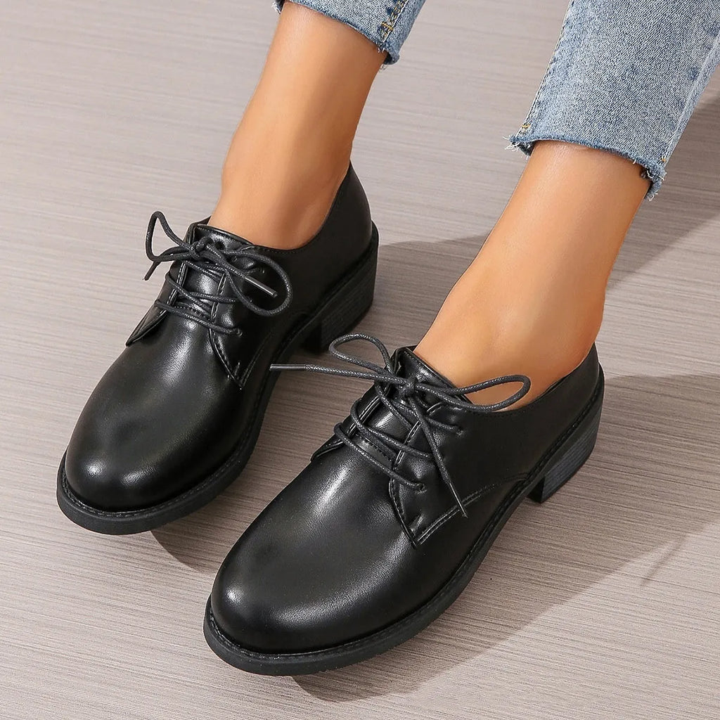 Black women's low-top work shoes with a thick chunky rubber heel and a PU leather upper