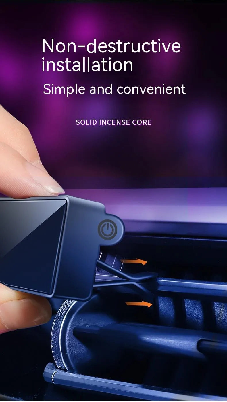 Black automobile aromatherapy LED light attached to a car air vent with a fragrance stick.