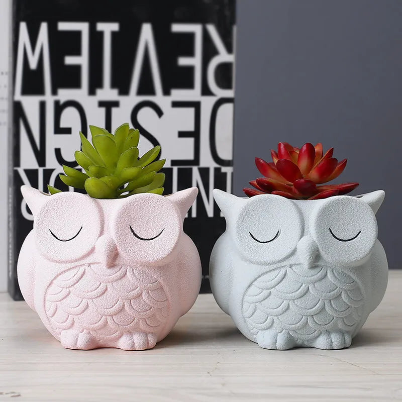 Handmade ceramic owl-shaped succulent plant pot in frosted light pink, shown from the front.