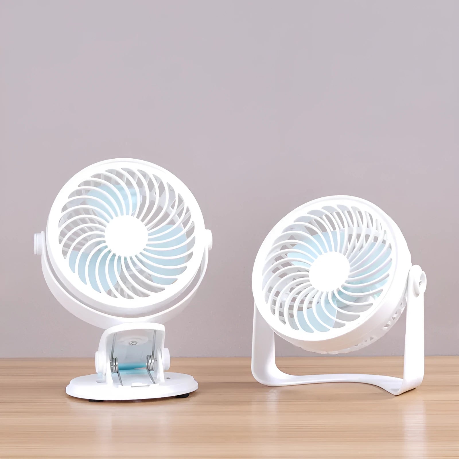 Small USB-powered desk fan shown in clip-on and floor-standing styles on a wooden desk.