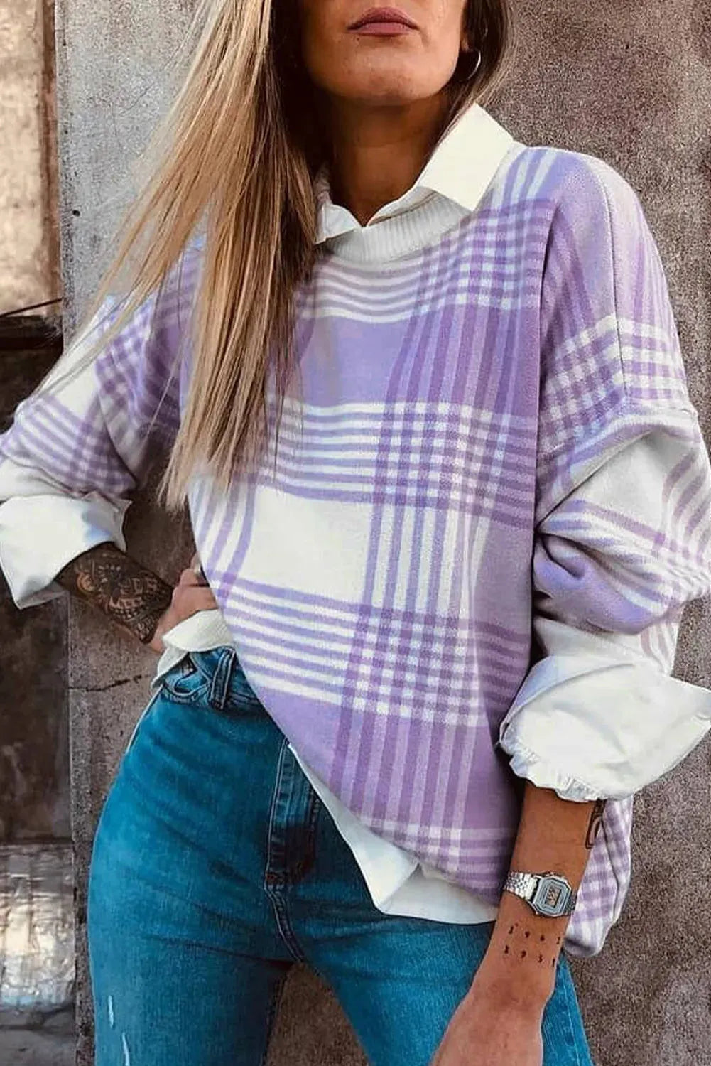 Loose lilac plaid print sweater with ribbed trim on a hanger