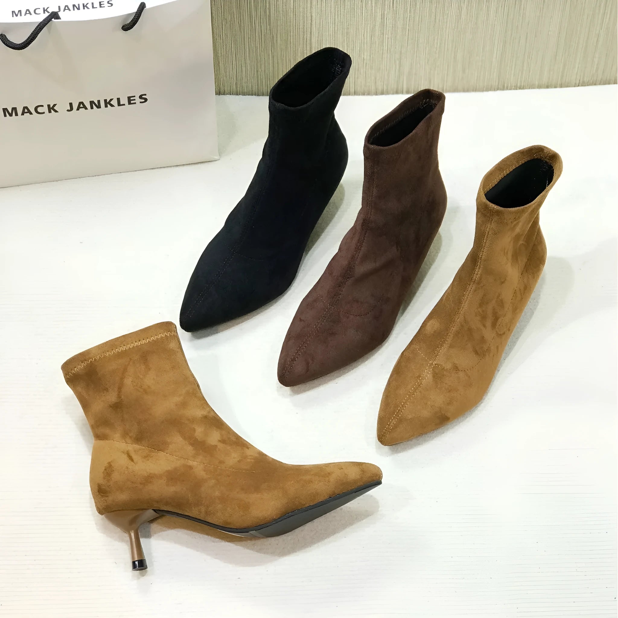 Women's black ankle boots with pointed toe and stiletto heel, mid-calf length