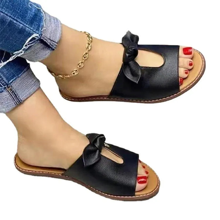 Women's fish mouth style sandals with a bow detail on the upper in black, pink, and gold colours