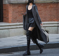 Long grey knitted cardigan trench coat with hood on a hanger.