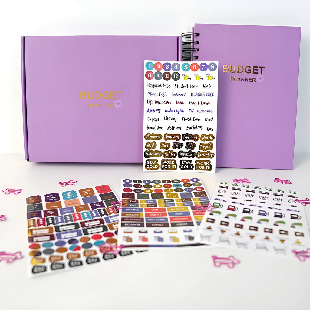 Purple coil-bound financial planning notebook with budget stickers and paper clips on A5 page