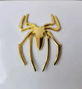 Gold 3D metal spider bumper sticker on a car bumper