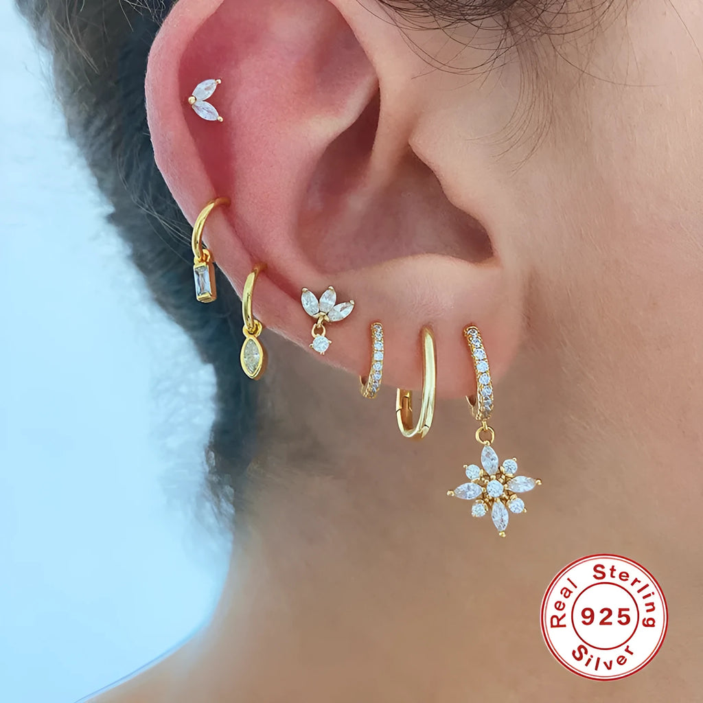 A pair of women's S925 sterling silver snowflake pendant earrings with a geometric design, available in yellow gold or white gold colour finishes.