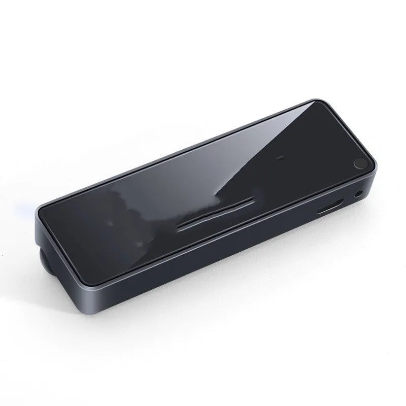 Black automobile aromatherapy LED light attached to a car air vent with a fragrance stick.