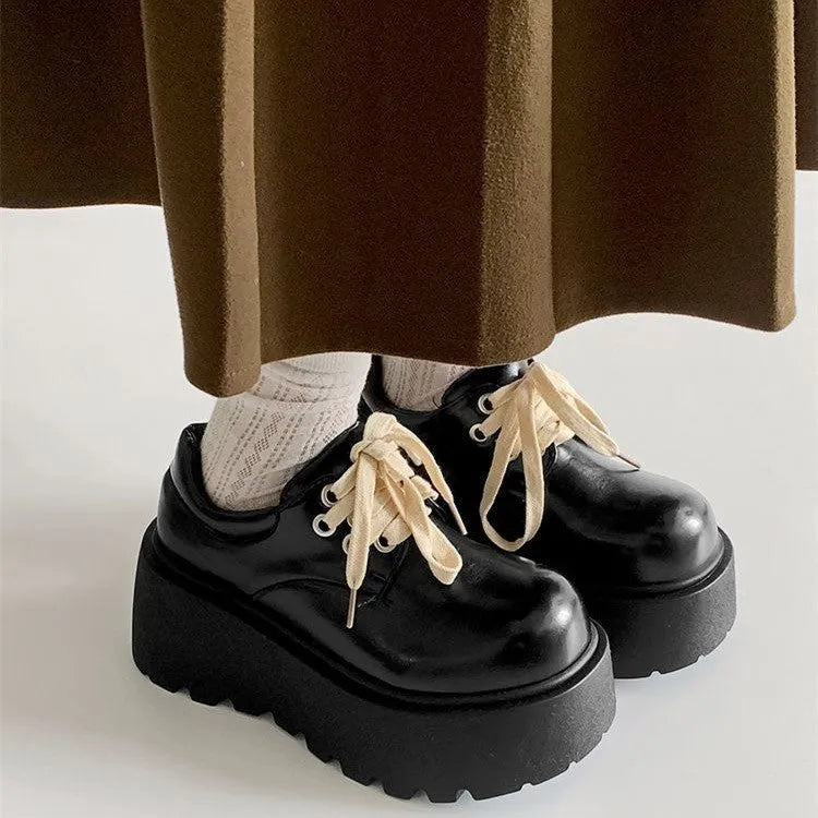Matte black women's lace-up ankle boots with a chunky heel and thick sole.