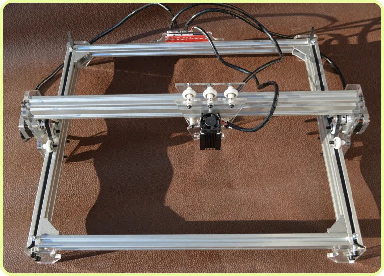 Miniature desktop laser engraving machine for marking and lettering with a 400mm x 300mm base plate.