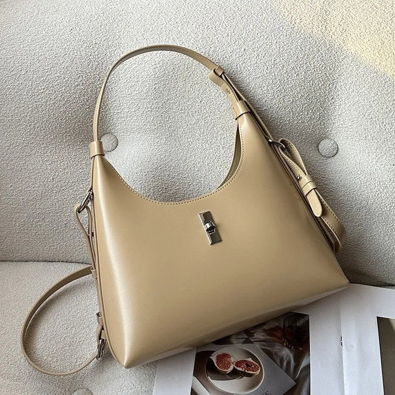 Women's soft genuine leather crossbody shoulder bag in a dumpling shape, shown in a light colour.