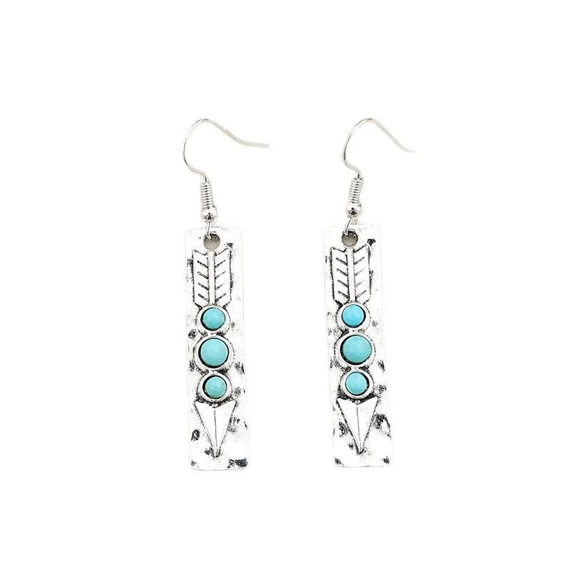 Silver geometric drop earrings with turquoise coloured inlays showing retro styling