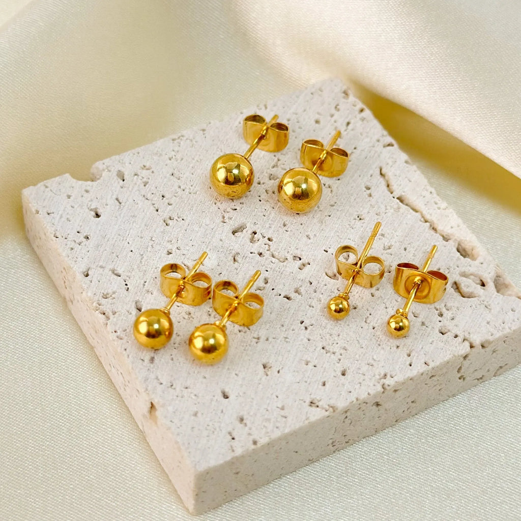 Stainless steel ball stud earrings in gold and silver tones, showing different sizes from 3mm to 6mm.