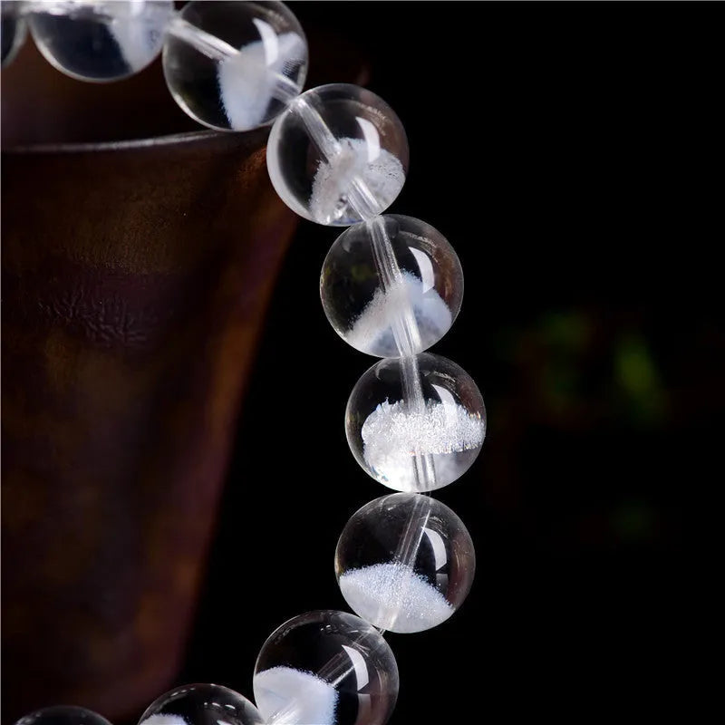 Women's white crystal ghost pyramid bracelet with Ruyi design element showing multiple purity size options