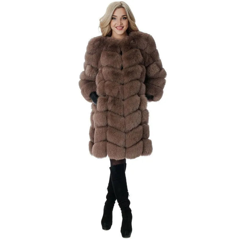 Women's long black artificial fur winter coat with regular sleeves on a hanger.