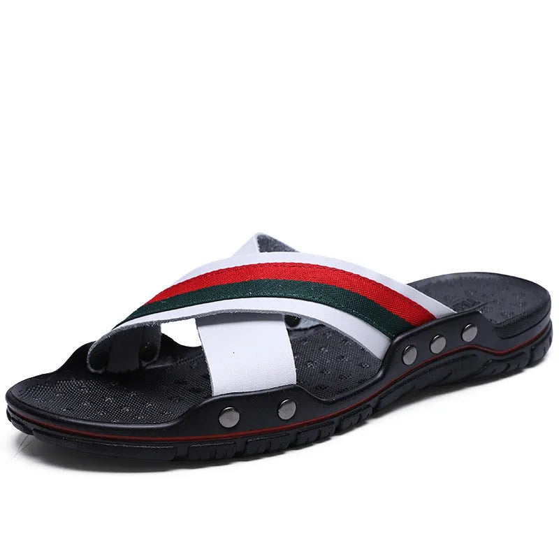 Men's cowhide leather beach flip-flops with non-slip sole in black, on a sandy background.