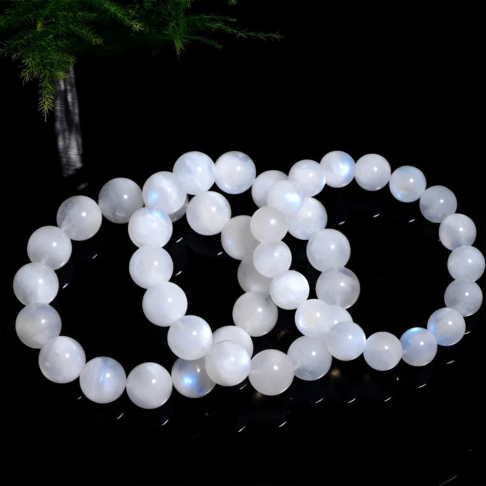 Natural blue moonlight round bead bracelet made from polished moonstone stones on a wrist.