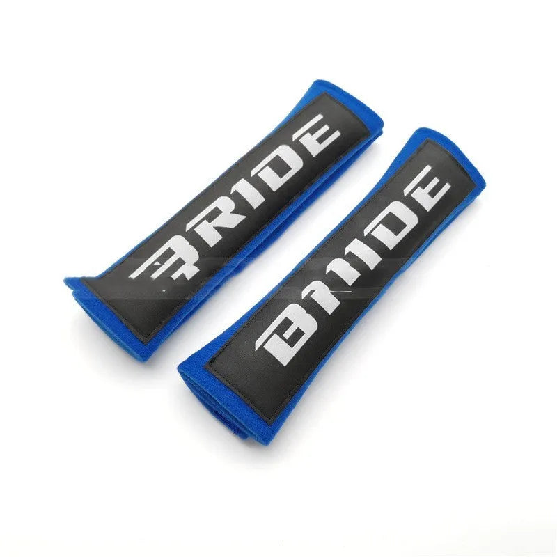 Car seatbelt shoulder pads in black, blue, and red colours showing cotton and sponge cloth embroidery weave construction