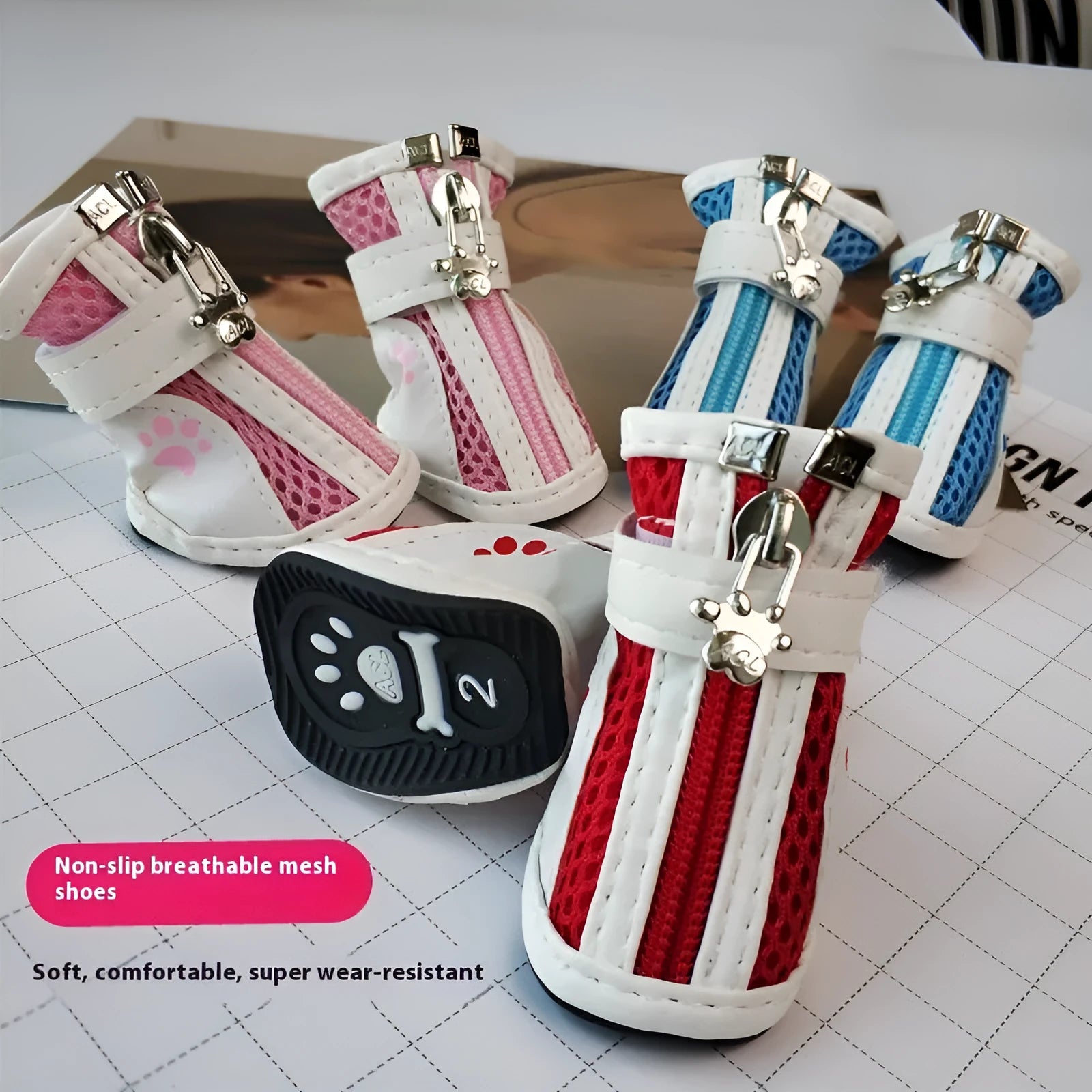Set of four blue cloth dog sneakers with zip fasteners and non-slip soles laid out.