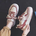 Low-top sneakers with rubber soles in beige and pink colour options showing height-increasing design