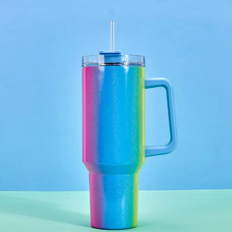 Large stainless steel vacuum insulation cup in a rainbow colour or gradient finish, showing its tall 27.5 cm height and wide 10 cm opening.