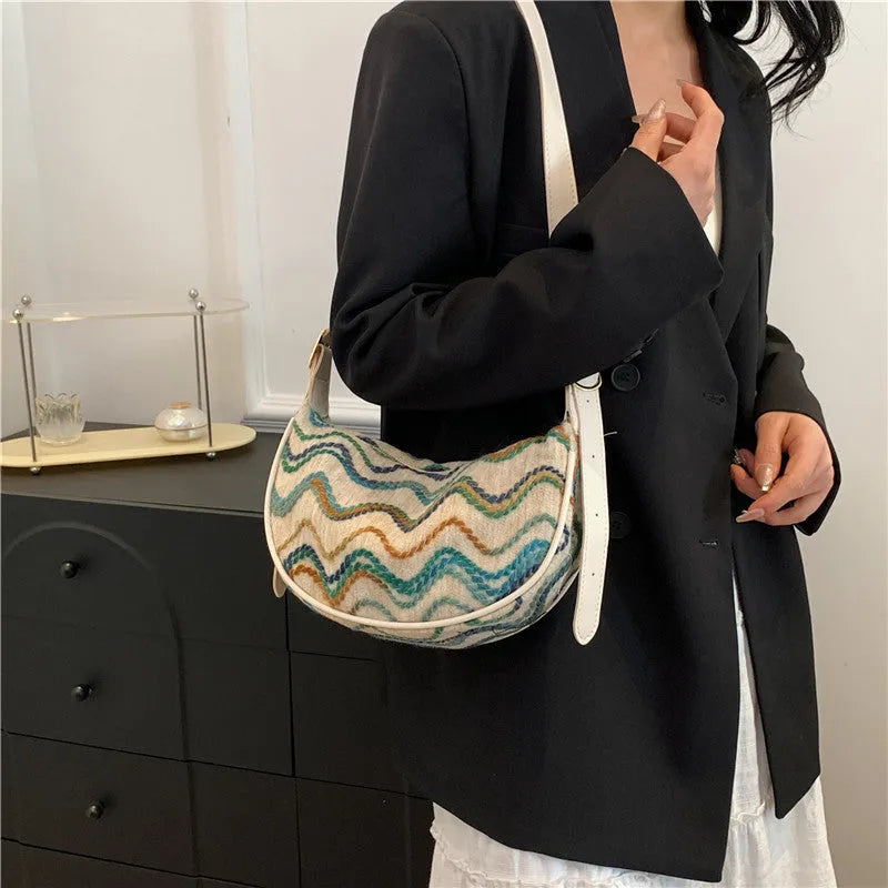 Women's woven straw crossbody bag with single strap and internal phone pocket