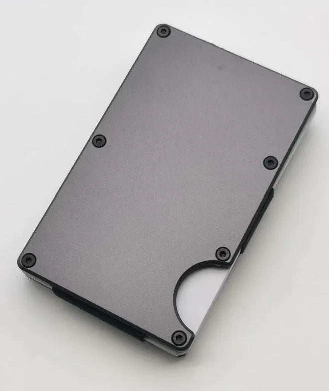 Aluminium alloy grey carbon fibre credit card wallet with RFID blocking feature, showing slim stowable profile.