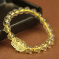 Yellow leather adjustable bracelet with citrine-coloured artificial crystal beads and a Chinese Pi Xiu charm.