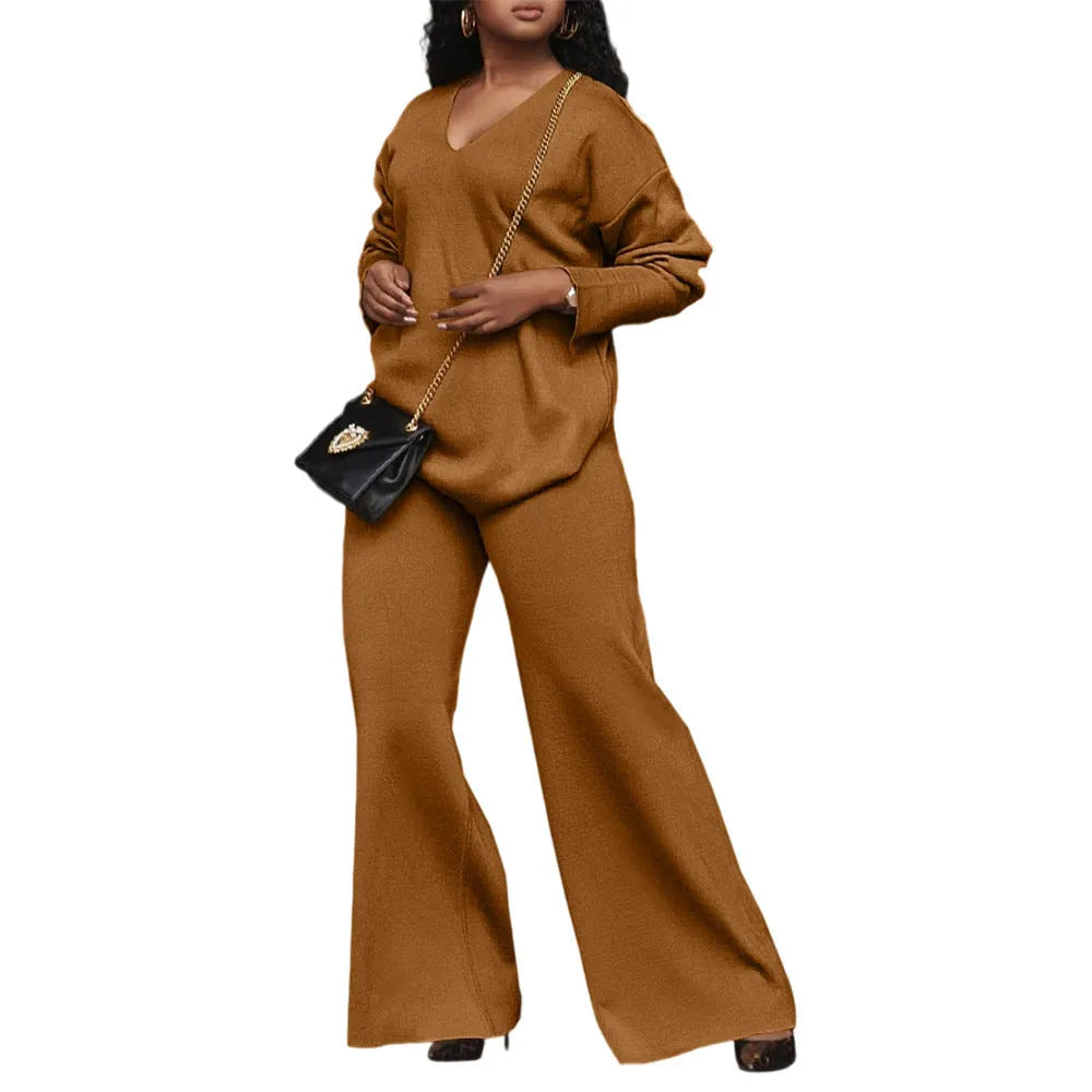Women's brown suede two-piece suit with long sleeves and trousers on a hanger