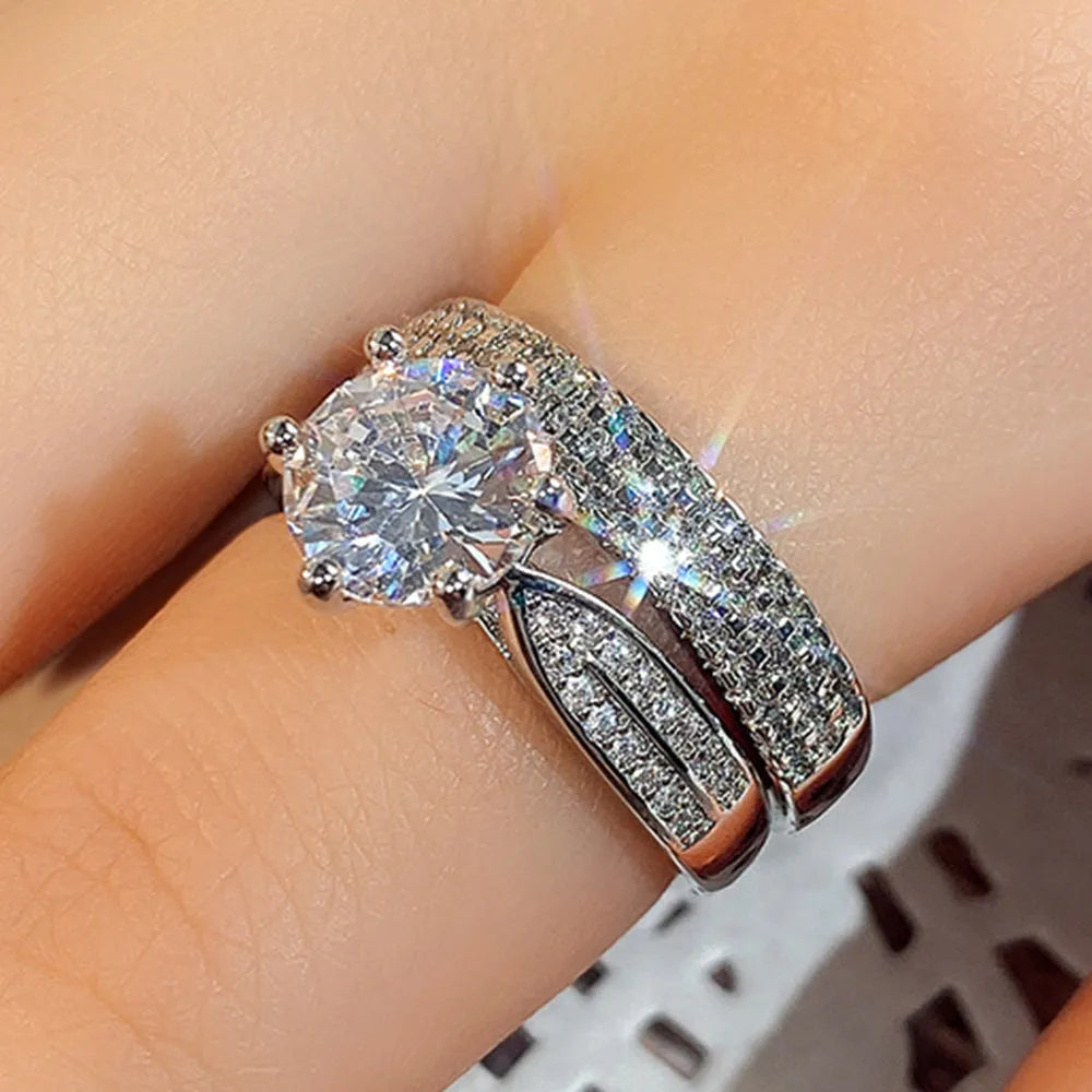 White gold colour geometric alloy wedding ring on a finger, showing its simple round band design.