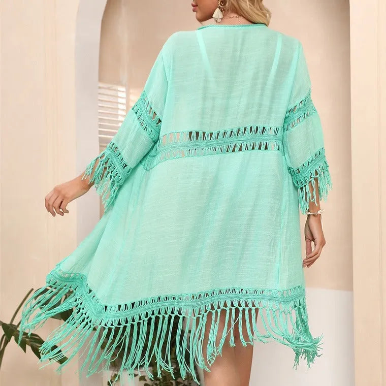 Yellow hand-crocheted acrylic beach cover-up cardigan for women on a hanger.
