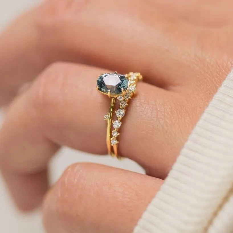 Gold plated women's flower ring with a green zircon stone, shown in sizes 6 to 10.
