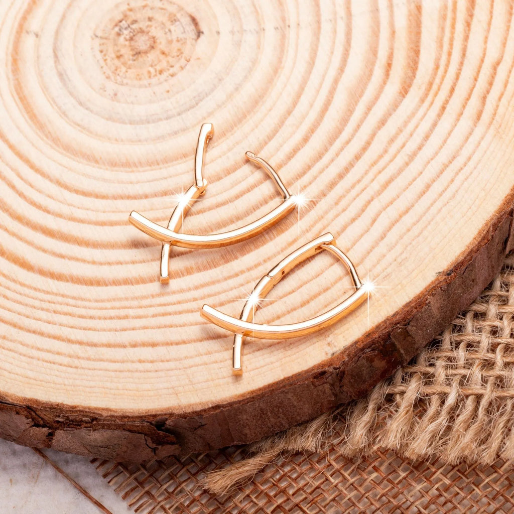 Cross shaped earrings in rose gold colour made from copper material