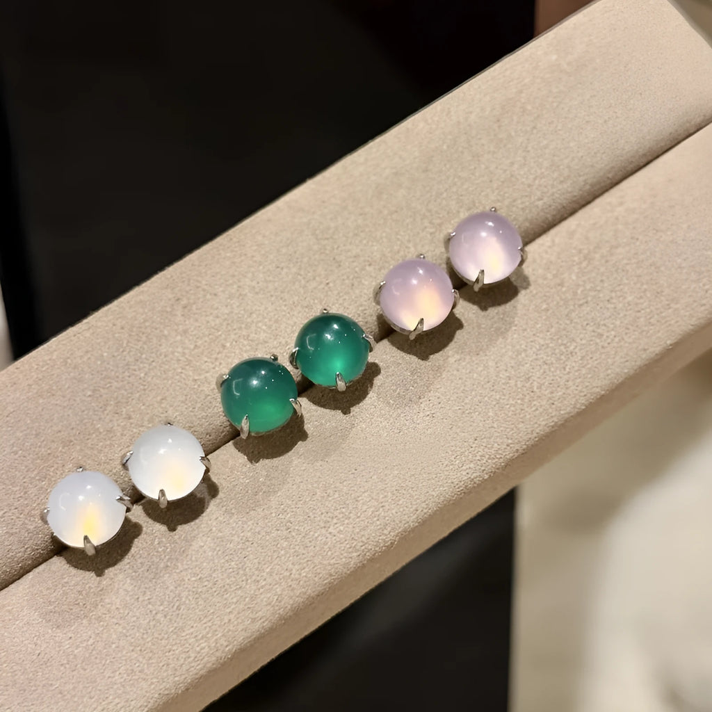 Chinese style chalcedony stud earrings with round egg surface stones in four claw settings