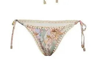 Women's creamy-white floral bikini set with removable skirt on size label