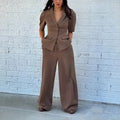 Brown men's slim fit polyester suit with long sleeves and trousers on a hanger